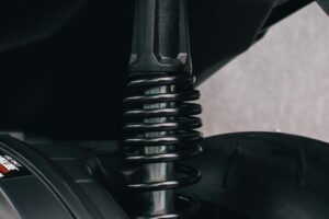 Detailed view of a motorcycle's suspension spring and metal components